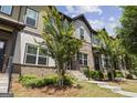 Charming townhome featuring a brick facade, manicured landscaping, and a welcoming entrance at 1004 Bayrose Cir, East Point, GA 30344