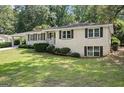 Lovely single-story home with white brick, a covered carport, and a well-manicured lawn at 2855 Briarlake Ne Rd, Atlanta, GA 30345