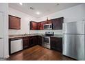 This kitchen features stainless steel appliances, granite countertops, and hardwood floors at 3155 Tarian Way, Decatur, GA 30034