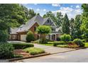Charming home featuring manicured landscaping and a circular driveway, enhancing its inviting curb appeal at 125 Franklin Pl, Atlanta, GA 30342