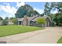 Features a well-maintained lawn, driveway, and a two-car garage on a charming home at 110 Chesterfield Ct, Fayetteville, GA 30214