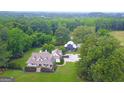 Expansive estate featuring a meticulously landscaped yard, detached building, and mature trees at 7093 Vaughn Rd, Canton, GA 30115