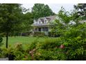 Charming home with landscaped yard, inviting porch, and well-maintained lawn at 7093 Vaughn Rd, Canton, GA 30115