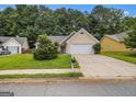 Inviting single-Gathering house featuring a well-kept lawn and a spacious driveway at 1055 Avalon Dr, Lawrenceville, GA 30044
