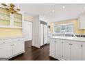 Bright, white kitchen with an island, modern appliances, and a breakfast nook area at 2917 Rockingham Nw Dr, Atlanta, GA 30327