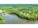 Picturesque aerial view of 115 Edgewater Way nestled on the shores of a serene lake surrounded by lush greenery at 115 Edgewater Way, Peachtree City, GA 30269