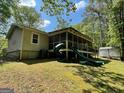 Spacious backyard features a screened-in porch and an oversized slide, perfect for outdoor entertainment and Gathering fun at 324 Bells Ferry Ne Rd, White, GA 30184