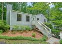 Beautiful home with lovely landscaping on the front hillside at 7025 Stone Wood Nw Dr, Kennesaw, GA 30152