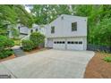 Exterior angle of home with a two-car garage and a large driveway at 7025 Stone Wood Nw Dr, Kennesaw, GA 30152