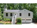 Charming two-story home with a two-car garage and steps up to front door at 7025 Stone Wood Nw Dr, Kennesaw, GA 30152
