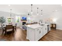 Spacious open concept with modern kitchen island, living room fireplace, and dining area at 1316 Willamette Way, Marietta, GA 30008