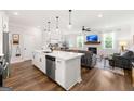 Bright open concept floor plan with modern kitchen island, living room fireplace, and dining area at 1316 Willamette Way, Marietta, GA 30008