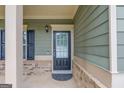 Front door with glass and black frame, front porch with traditional features at 2030 Beyers Landing Dr, Buford, GA 30519
