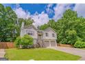 Beautiful two-story home featuring an attached two-car garage, complemented by a lush, green lawn at 3781 Deercreek Dr, Powder Springs, GA 30127