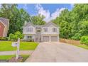 Charming two-story home with a two-car garage, landscaped front yard, and a welcoming front entrance at 3781 Deercreek Dr, Powder Springs, GA 30127