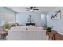 Comfortable living room with a neutral color palette, plush sofa, large window, and modern decor for relaxation and style at 1694 Pheasant Dr, Atlanta, GA 30238