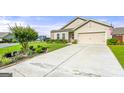 Inviting home featuring a manicured lawn and a lengthy concrete driveway at 3735 Westhaven Dr, Cumming, GA 30040