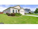 Landscaped front yard leading to a charming home with a two-car garage at 3735 Westhaven Dr, Cumming, GA 30040