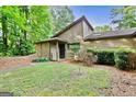 Beautiful home with a well-manicured lawn and lush greenery creating a serene setting at 830 Bonnie Glen Se Dr, Marietta, GA 30067