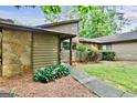 Delightful home with a mix of stone and siding exterior, complemented by vibrant plants at 830 Bonnie Glen Se Dr, Marietta, GA 30067