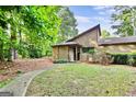 Charming home featuring a well-kept lawn, mature trees, and a welcoming walkway at 830 Bonnie Glen Se Dr, Marietta, GA 30067