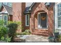 Close-up of the front entrance, showcasing the arched brick entryway and decorative wreath on the front door at 2689 Spring Rock Ne Ct, Roswell, GA 30075