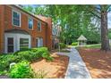 Exterior view showcasing a gazebo down a walkway on the property with mature tree coverage at 4113 Ashford Green Dr, Duluth, GA 30096