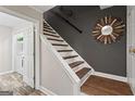 Interior staircase featuring hardwood treads, white risers, and a decorative mirror at 4113 Ashford Green Dr, Duluth, GA 30096