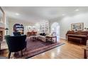 Elegant living room with hardwood floors, fireplace, built-in shelving, and classic furnishings at 3030 Spalding Dr, Sandy Springs, GA 30350