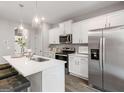 Stylish kitchen with stainless appliances, white cabinetry, a large island, and pendant lighting at 5615 Hislop Ln # 82, Mableton, GA 30126