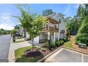 View of the side of the townhome featuring a garage and small second story balcony at 774 Belrose Dr, Smyrna, GA 30080