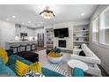 Open-concept living room features a modern fireplace, built-in shelves, and adjoins the kitchen at 774 Belrose Dr, Smyrna, GA 30080