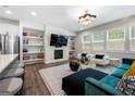 Open-concept living room with modern fireplace, built-in shelves, and lots of windows for natural light at 774 Belrose Dr, Smyrna, GA 30080