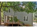 Back of the home featuring a deck, stairs, and wooded lot at 3 Maplelake Dr, Acworth, GA 30101
