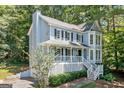 View of the charming two-story home with a welcoming front porch and lush landscaping at 3 Maplelake Dr, Acworth, GA 30101
