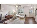 Bright living room featuring a modern fireplace, plush sofa, and stylish decor at 1911 Stancrest Nw Trce, Kennesaw, GA 30152