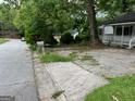 Street view of a property with a classic mailbox, paved parking area, and partial house view at 766 Warren Dr, Riverdale, GA 30296