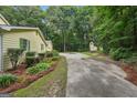 Long driveway leading to a charming two-story home surrounded by trees and greenery at 2110 Waterloo Cir, Lawrenceville, GA 30043
