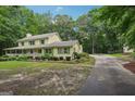 Side view of two-story home with charming landscaping, and a long concrete driveway at 2110 Waterloo Cir, Lawrenceville, GA 30043