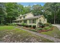 Side view of two-story home with charming landscaping and concrete walkway at 2110 Waterloo Cir, Lawrenceville, GA 30043