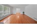 Spacious living room with gleaming hardwood floors and large windows at 3332 Saint John Dr, East Point, GA 30344