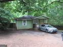 Charming single-story home with a cozy porch and easy parking, nestled amidst lush greenery at 118 Tye St, Stockbridge, GA 30281