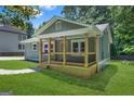 Attractive home featuring a cozy front porch with wooden columns and a lush green yard at 1675 White Oak Way, Decatur, GA 30032