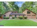 Charming two-story home with a well-manicured lawn, stone accents, and an attached two-car garage at 4920 Tremont Ne Dr, Marietta, GA 30066