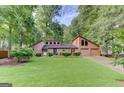 Charming two-story home with a well-manicured lawn, mature trees, and an attached two-car garage at 4920 Tremont Ne Dr, Marietta, GA 30066