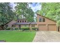 Charming two-story home with a well-manicured lawn, stone accents, and an attached two-car garage at 4920 Tremont Ne Dr, Marietta, GA 30066