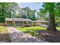 Well maintained single story home with a long driveway surrounded by beautiful mature trees at 2985 Westbury Dr, Decatur, GA 30033