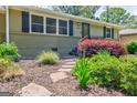 Up-close view of landscaped front yard with stone steps leading to the front door of the home at 2985 Westbury Dr, Decatur, GA 30033