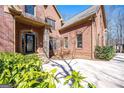 Stately brick home showcasing an arched entryway and meticulously landscaped front yard at 297 Collegiate Dr, Powder Springs, GA 30127