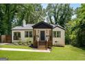 Inviting exterior featuring a well-maintained lawn, freshly painted brick, and inviting front porch at 345 Adelle Se St, Atlanta, GA 30315